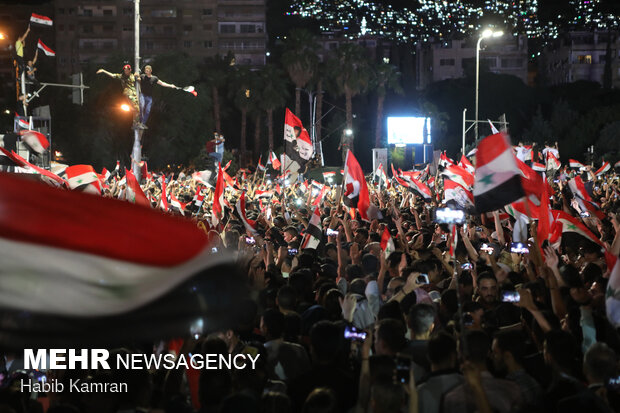 Syrian people celebrating victory of Bashar Asad in election