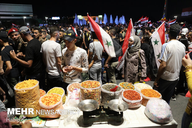 Syrian people celebrating victory of Bashar Asad in election