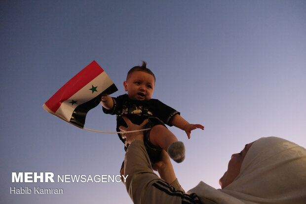 Syrian people celebrating victory of Bashar Asad in election