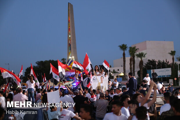 Syrian people celebrating victory of Bashar Asad in election