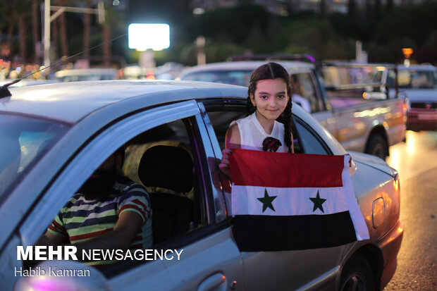 Syrian people celebrating victory of Bashar Asad in election