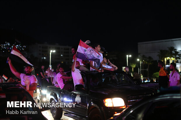 Syrian people celebrating victory of Bashar Asad in election