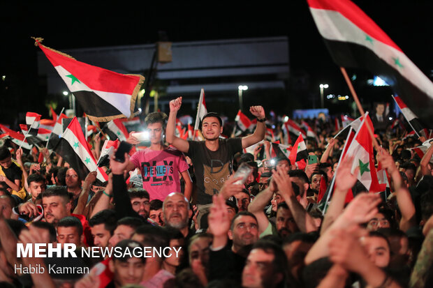 Syrian people celebrating victory of Bashar Asad in election