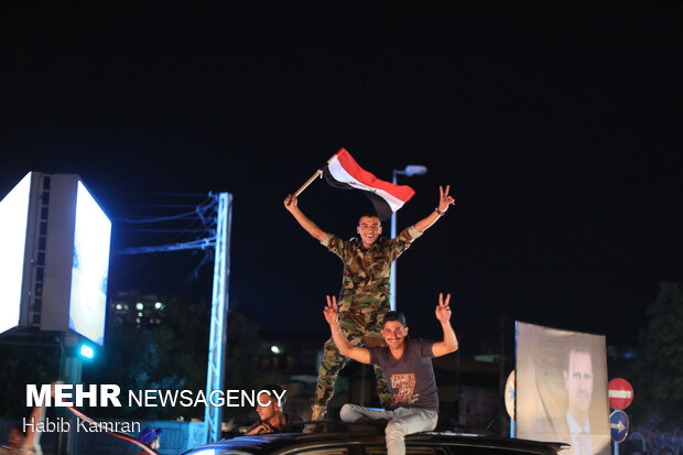 Syrian people celebrating victory of Bashar Asad in election