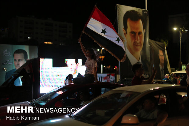 Syrian people celebrating victory of Bashar Asad in election