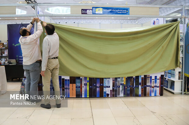 غرفه داران در حال بستن غرفه های خود در پایان ساعت کاری چهارمین روز سی و سومین نمایشگاه کتاب تهران هستند