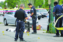 U.S. “terror” as rooftop gunman opens fire on parade 