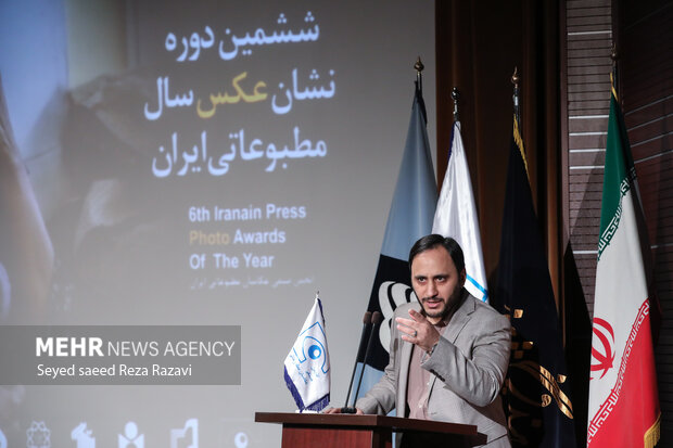 علی بهادری جهرمی، سخنگو و دبیر هیئت دولت در حال سخنرانی در مراسم ششمین دوره نشان عکس سال مطبوعاتی است