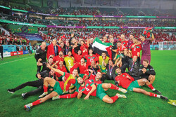 Morocco players celebrate with Palestinian flag