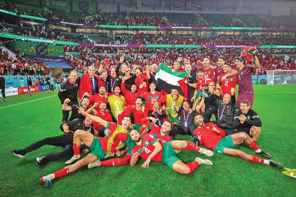 Morocco players celebrate with Palestinian flag