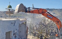 A Palestinian forced to demolish his house