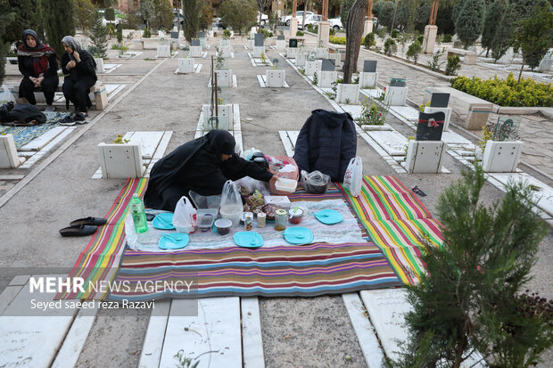 Iftar at cemetery alongside martyrs graves