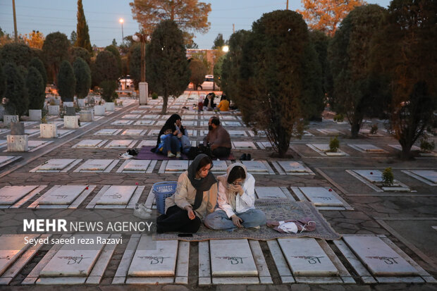 Iftar at cemetery alongside martyrs graves