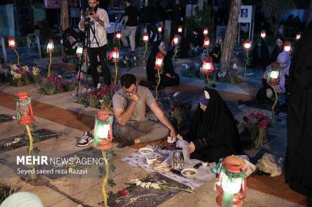 Iftar at cemetery alongside martyrs graves