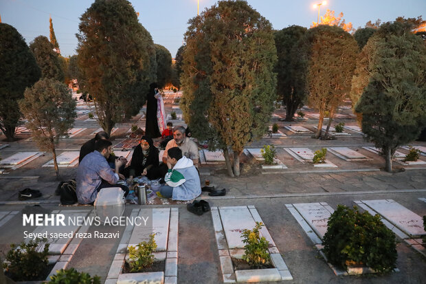 Iftar at cemetery alongside martyrs graves