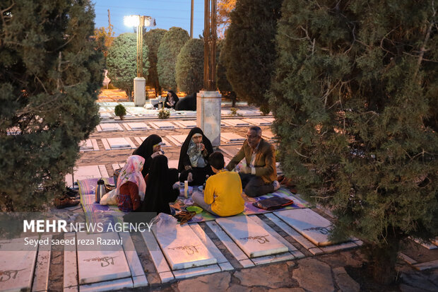 Iftar at cemetery alongside martyrs graves