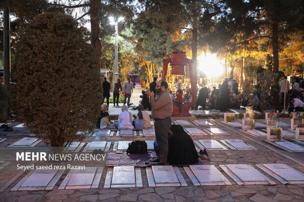 Iftar at cemetery alongside martyrs graves