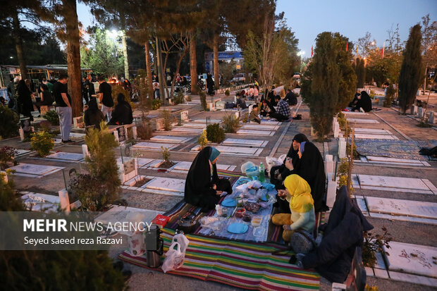 Iftar at cemetery alongside martyrs graves