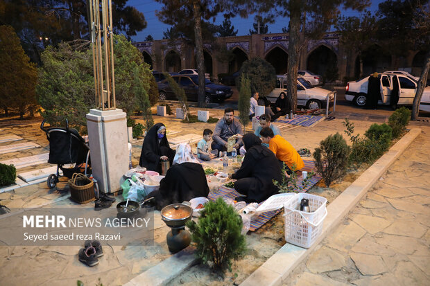 Iftar at cemetery alongside martyrs graves