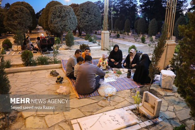 Iftar at cemetery alongside martyrs graves