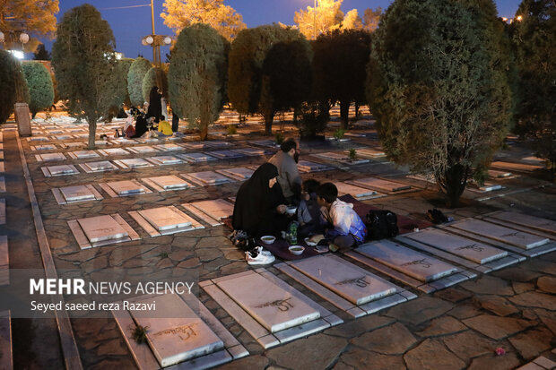 Iftar at cemetery alongside martyrs graves
