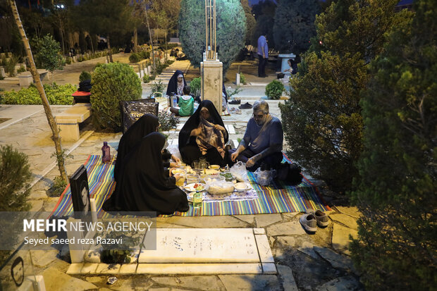 Iftar at cemetery alongside martyrs graves