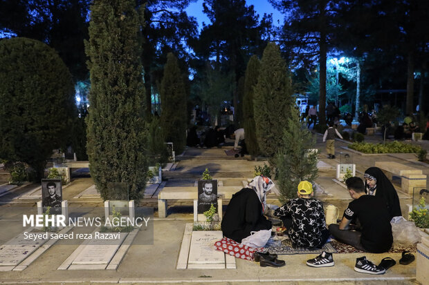 Iftar at cemetery alongside martyrs graves