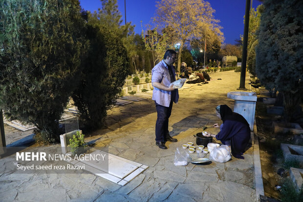 Iftar at cemetery alongside martyrs graves