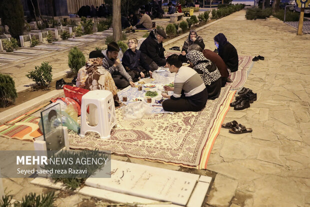 Iftar at cemetery alongside martyrs graves