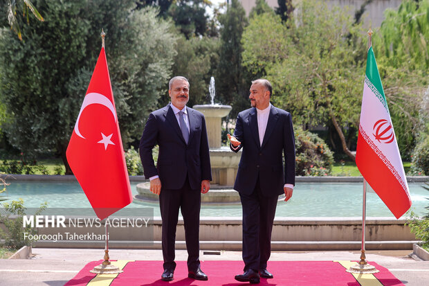 حسین امیر عبداللهیان، وزیر امور خارجه ایران در حال استقبال از هاکان فیدان، وزیر امور خارجه ترکیه در محل دیدار وزرای خارجه ترکیه و ایران است 