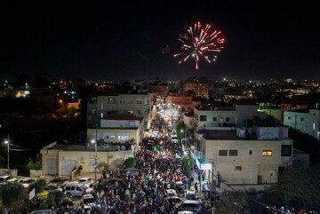 Palestinians Jubilant as Israelis Look on with Concern 
