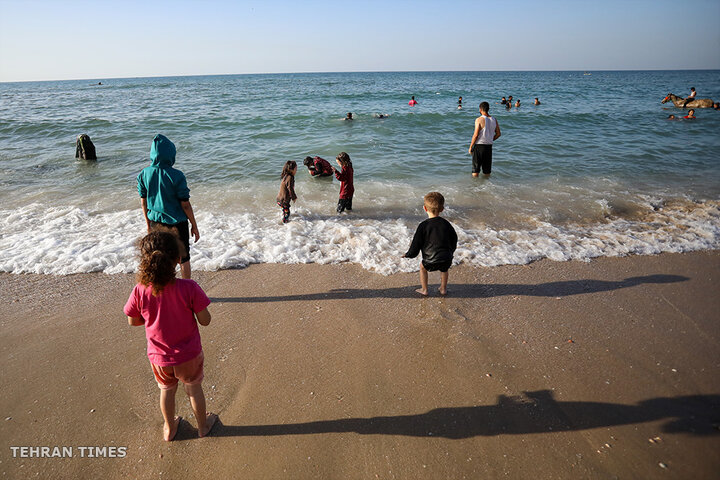 ‘Our only outlet’: Palestinians in Gaza go to the beach during Israel truce