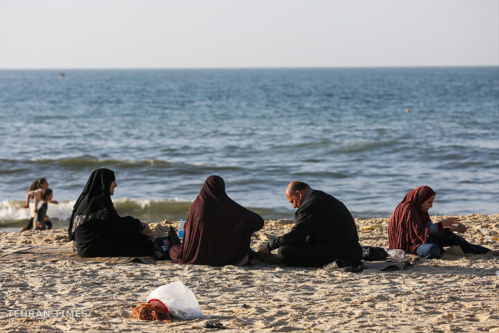 ‘Our only outlet’: Palestinians in Gaza go to the beach during Israel truce