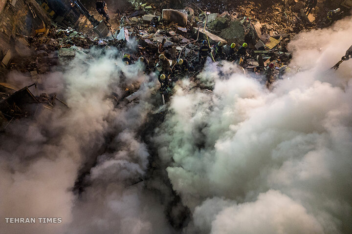 Emergency workers clear the rubble after a Russian rocket hit a multi-storey building, leaving many people under debris in the southeastern city of Dnipro, Ukraine, on January 14. [Evgeniy Maloletka/AP Photo]