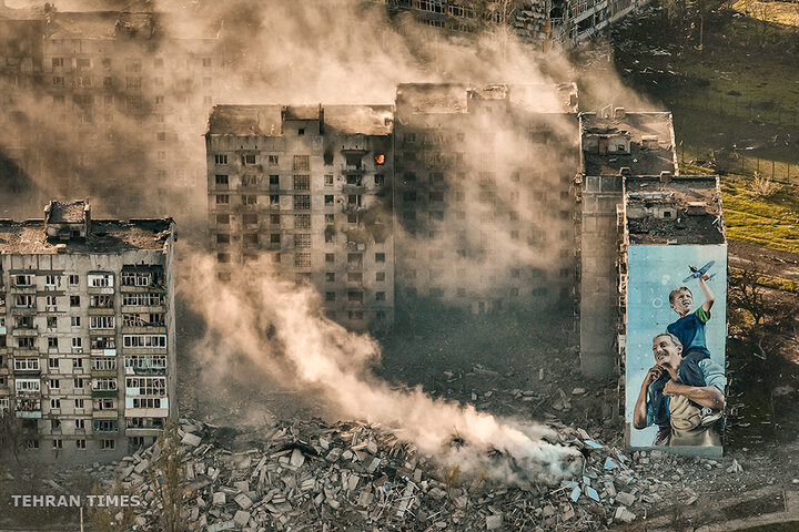 Smoke rises from a building in Bakhmut, the site of long and fierce battles between Russian and Ukrainian troops in the Donetsk region, Ukraine, on April 26. [Libkos/AP Photo]