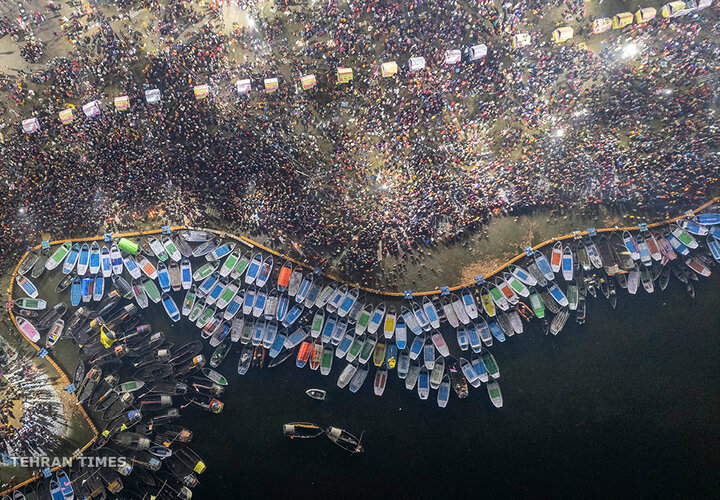 Hindu devotees crowd the Sangam, the confluence of the rivers Ganges, Yamuna and the mythical Saraswati, to take a holy dip on Mauni Amavasya or New Moon Day, the most auspicious day during the annual month-long Hindu religious fair 'Magh Mela' in Prayagraj, India, on January 21. [Satya Prakash/AP Photo]