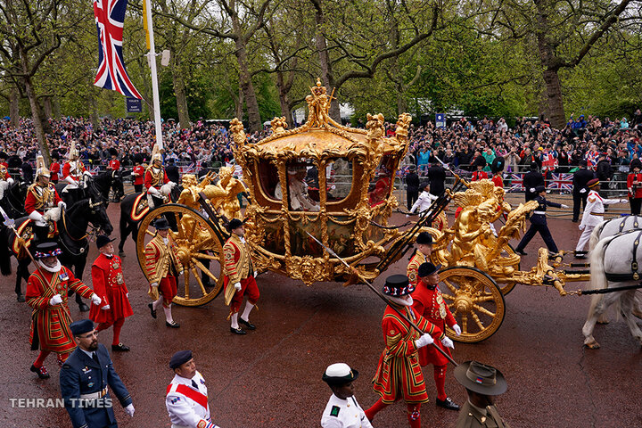 Britain's King Charles III and Queen Camilla travel in the Gold State Coach from Westminster Abbey to Buckingham Palace following their coronation ceremony in London, on May 6. [Alberto Pezzali/AP Photo]