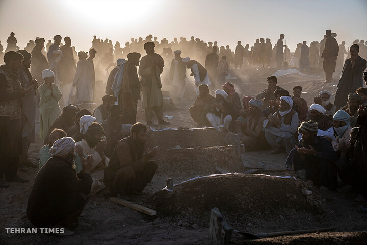 Afghans in Zenda Jan district, Herat province, Afghanistan, bury hundreds of people killed in an earthquake in early October. A series of earthquakes killed and injured thousands and levelled an untold number of homes. [Ebrahim Noroozi/AP Photo]
