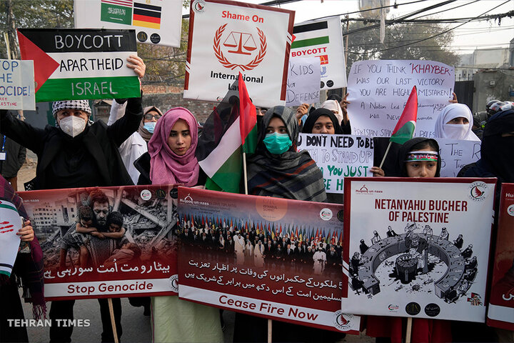 Pakistani people hold placards during a protest against Israeli air raids and to show solidarity with Palestinians, in Lahore, Pakistan. [KM Chaudary/AP Photo]
