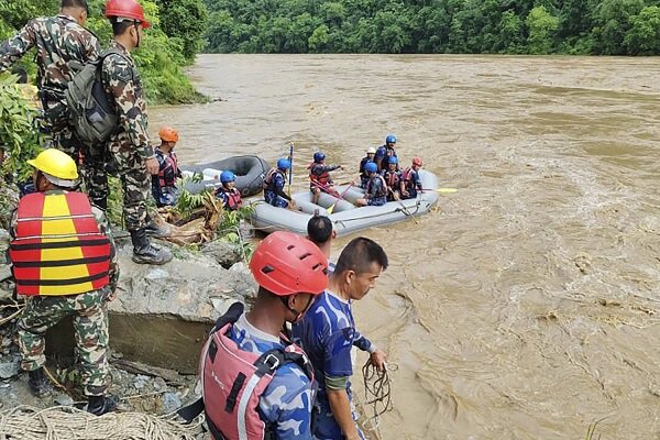 2 buses carrying over 50 people swept into river by landslide