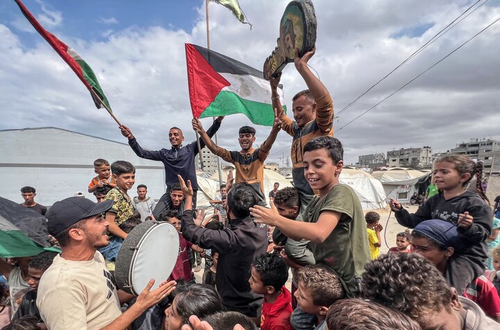 Palestinians celebrate in Nusairat camp on Thursday, October 10, 2025 after news of a Gaza ceasefire deal.