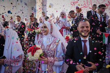 Palestinians celebrate as young couples attend mass wedding