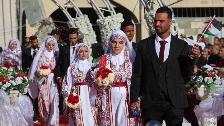 Palestinians celebrate as young couples attend mass wedding