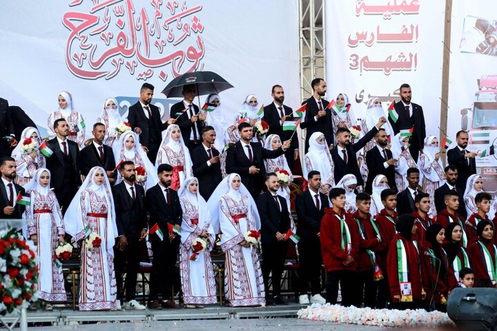 Palestinians celebrate as young couples attend mass wedding