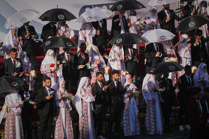 Palestinians celebrate as young couples attend mass wedding