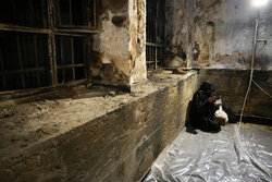 Performing prayers at burnt Hojjatieh Mosque in Rasht