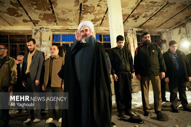 Performing prayers at burnt Hojjatieh Mosque in Rasht
