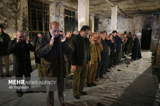 Performing prayers at burnt Hojjatieh Mosque in Rasht
