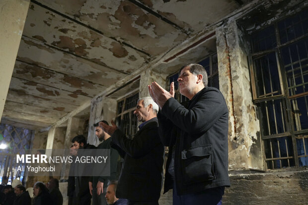 Performing prayers at burnt Hojjatieh Mosque in Rasht
