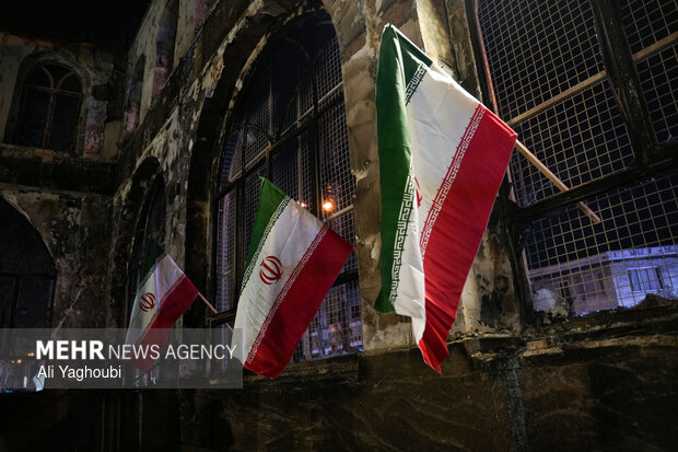 Performing prayers at burnt Hojjatieh Mosque in Rasht
